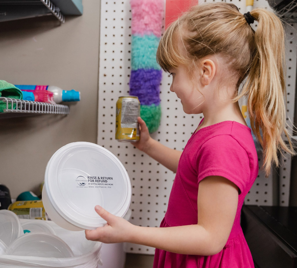 Small girl holding earthware container